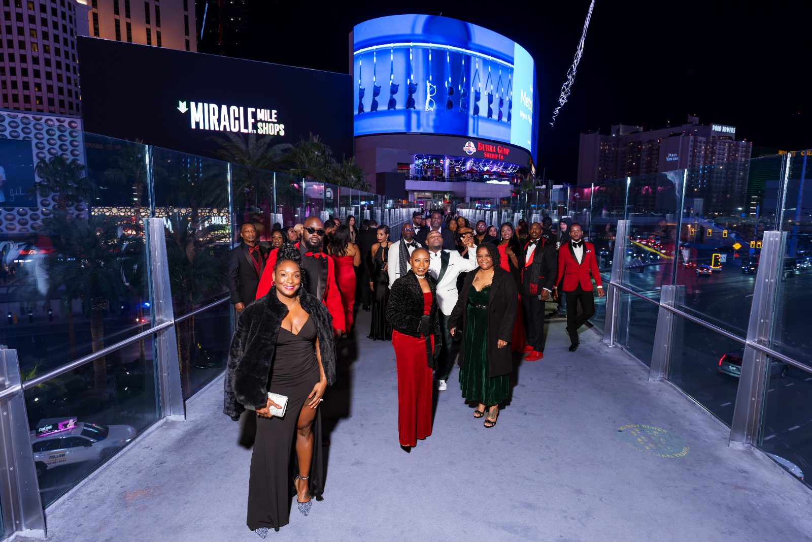 Las Vegas concert photoshoot — the whole party walking the Strip in black tie before the show